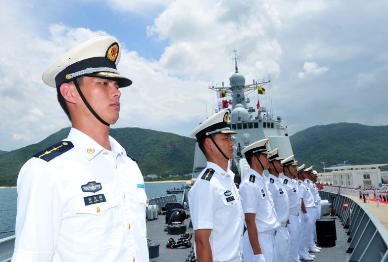 In this Monday, June 9, 2014 photo released by China's Xinhua News Agency, Chinese naval soldiers stand on China's missile destroyer Haikou at a naval port in Sanya, south China's Hainan Province. The Chinese naval squadron has left port to take part for the first time in the world's largest naval exercises hosted by the U.S. in waters near Hawaii, the Defense Ministry said Tuesday. China's participation in the Rim of the Pacific exercises is seen as an opportunity to build mutual trust amid tensions at sea with neighbors ranging from Vietnam and the Philippines to the south, to Japan in the east. (AP Photo/Xinhua, Hu Kaibing) NO SALES