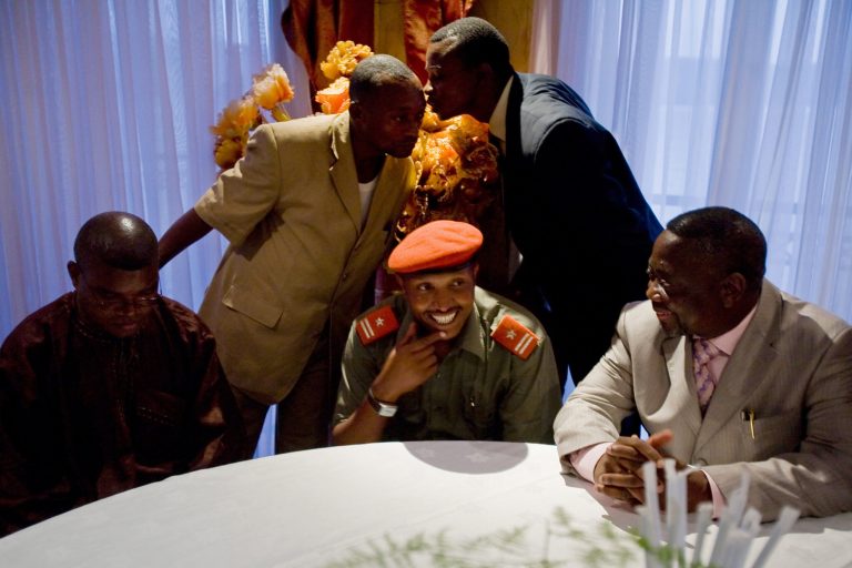 FILE - In this Jan. 16, 2009 file photo, Bosco Ntaganda, seated center, holds a press conference with Congo Interior Minister Celestine Mboyo, right, in Goma, Congo, as rebel leader Ntaganda agreed to work with the Congolese government. The government of Rwanda said Monday, March 18, 2013, that Ntaganda, who had been on the run in neighboring Congo, had turned himself in to the United States Embassy in Kigali, the capital of Rwanda. Ntaganda has become one of Africa's symbols of impunity. Despite an outstanding warrant from the International Criminal Court, which indicted him on war crimes in 2006, he became a general in the Congolese army, living in an upscale villa and playing tennis in his spare time.(AP Photo/T.J. Kirkpatrick, File)