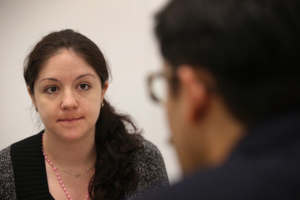 NEW YORK, NY - JANUARY 31:  Immigration attorney Andres Lemons advises Evie Gomez on her U.S. citizenship application on January 31, 2013 in New York City. The Canadian immigrant is soon to have a baby and is working through the long process with her husband to become U.S. citizens. Lemons works at the CUNY Citizenship Now 