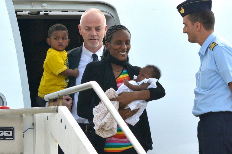Meriam Ibrahim, from Sudan, holds her baby girl Maya, accompanied by Italian deputy Foreign Minister Lapo Pistelli, holding her son Martin, after landing from Khartoum, at Ciampino's military airport, on the outskirts of Rome, Thursday, July 24, 2014. (AP Photo/Daniele Leone, Lapresse)