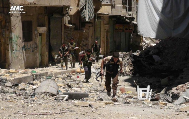 Free Syrian army fighters run for cover during clashes with government forces in Aleppo. (AP Photo/Aleppo Media Center)