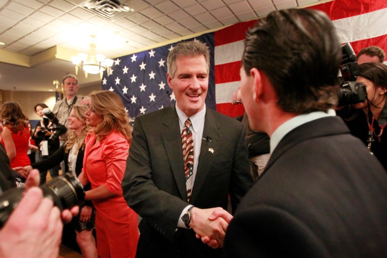 Former Massachusetts U.S. Sen. Scott Brown, center, is greeted by supporters after announcing his plans to run for U.S. senator in New Hampshire last month. Brown and Rep. Paul Ryan, R-Wisconsin, were the only current or former elected officials featured at the three-day gathering hosted by hedge fund firm SkyBridge Capital. (AP Photo/Jim Cole)