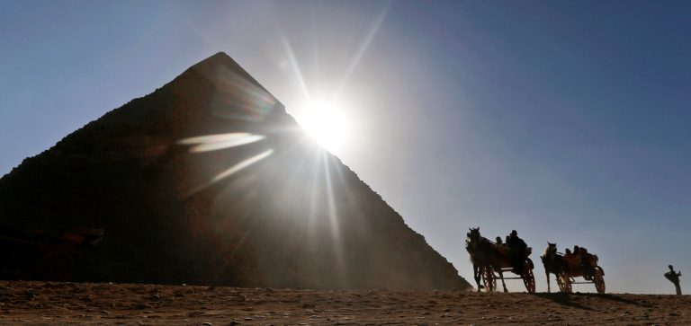   FILE - In this Wednesday, Dec. 12, 2012 file photo, Tourists ride in horse carriages past one of the Great Pyramids in Giza, Egypt. The past month saw a drop in tourists to Egypt, scared off by scenes of protests and clashes over the constitution, in new pain to a crucial industry gutted the past two years by turmoil. Tourism workers worry things wonât get any better even now that the charter has been passed: Egyptâs power struggles threaten to erupt into more unrest at any time, and some fear Islamists will eventually try to rein in alcohol and beach tourism. (AP Photo/Petr David Josek, File)  