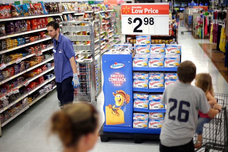  FILE - In this Friday, July 12, 2013, file photo, shoppers peruse the aisles at a Wal-Mart in Bristol, Pa. Americans increased their spending at an annual rate of just 1.8 percent in the April-June quarter, down from a 2.3 percent rate in the January-March period. Consumer spending is expected to improve in the second half of the year. But most economists foresee only a slight acceleration to an annual rate of 2 percent to 2.5 percent. (AP Photo/Matt Rourke, File)  