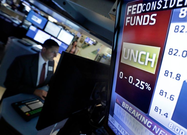 A television screen on the floor of the New York Stock Exchange shows the rate decision by the Federal Reserve, as specialist Jeffrey Berger works at his post, Wednesday, July 31, 2013. The Federal Reserve says the U.S. economy is growing modestly, a downgrade from its June assessment. The Fed expects growth will pick up in the second half of the year, but the more cautious message may signal it's not ready to slow its bond purchases soon. (AP Photo/Richard Drew)