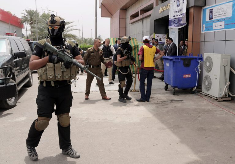 Iraqi security forces stand guard outside a vote counting center in Baghdad, Iraq, Thursday, May 8, 2014. Iraq voted Wednesday in its first nationwide election since U.S. troops withdrew in 2011, with Prime Minister Nouri al-Maliki confident of victory and even offering an olive branch to his critics by inviting them to join him in a governing coalition. (AP Photo/ Khalid Mohammed)