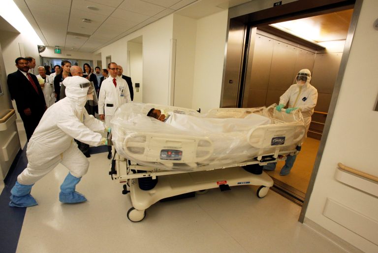 In this photo provided by the UCLA Health System, doctors and staff participate in a preparedness exercise on diagnosing and treating patients with Ebola virus symptoms, at the Ronald Reagan UCLA Medical Center in Los Angeles. (AP Photo/UCLA Health System, Reed Hutchinson)