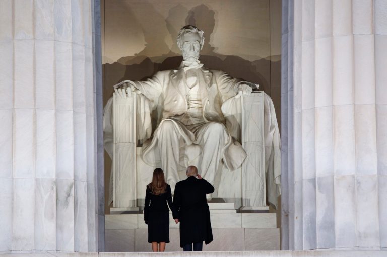 President Trump, right, salutes as he arrives with his wife, Melania Trump, to the 