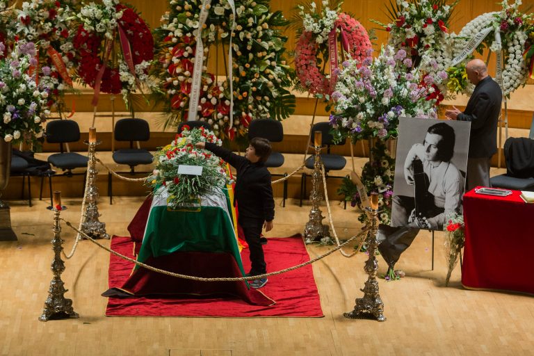 Diego places a flower on the coffin of his father, flamenco guitarist, Paco de Lucia during a wake in the National Auditorium in Madrid,  Spain, Friday, Feb. 28, 2014. Paco de Lucia, one of the world's greatest guitarists who dazzled audiences with his lightning-speed flamenco rhythms and finger work, died in Mexico on Wednesday Feb. 26 aged 66. Another wake is planned in his native town of Algeciras in southern Spain Saturday and he will be buried afterwards. (AP Photo/Andres Kudacki)