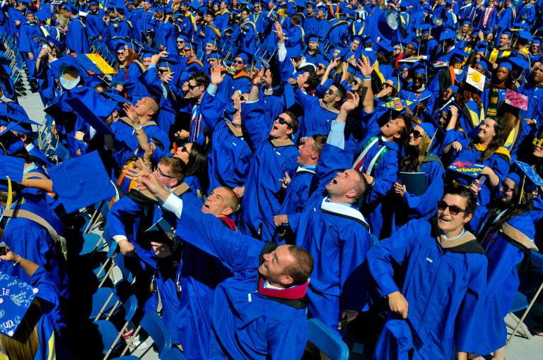 In this May 31, 2014 file photo, graduates throw their caps in the air in triumph at the University of Delaware's commencement ceremony in Newark, Del. (AP Photo/Emily Varisco)