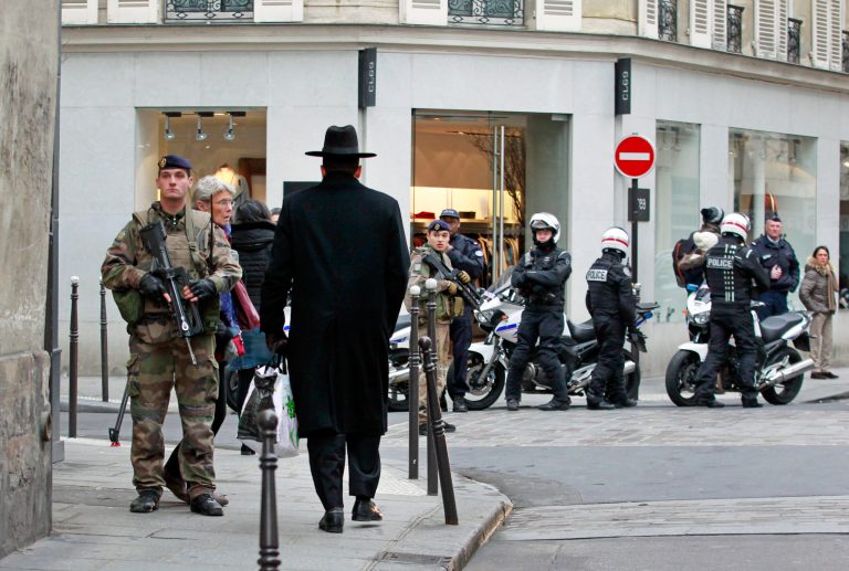 Police officers and French army soldiers patrol Rue des Rosiers street, in the heart of Paris Jewish quarter, in Paris, Monday. (AP/Remy de la Mauviniere)