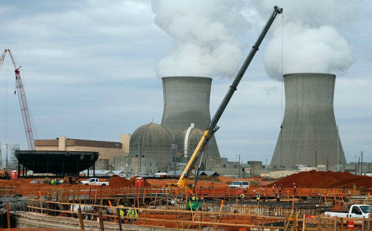 In this photo taken Tuesday, Dec. 11, 2012 part of the containment vessel for a new nuclear reactor at the Plant Vogtle nuclear power plant is shown under construction in Augusta, Ga., With the cost of nuclear plants rising, a handful of state officials are showing signs of buyer's regret. The reservations come as two of the three nuclear plants under construction have faced cost overruns just as electricity generated by natural gas has gotten cheaper. (AP Photo/John Bazemore)