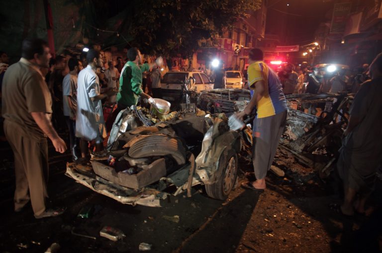 Palestinians search the wreckage of vehicle reportedly belonging to a taxi driver working for a local media company following an Israeli air strike in Gaza City. Wednesday, July 9, 2014. Israel stepped up its offensive on the Hamas-run Gaza Strip on Wednesday, pummeling scores of targets and killing more than a dozen people as Israeli leaders signaled a weeks-long ground invasion could be quickly approaching. (AP Photo/Khalil Hamra)