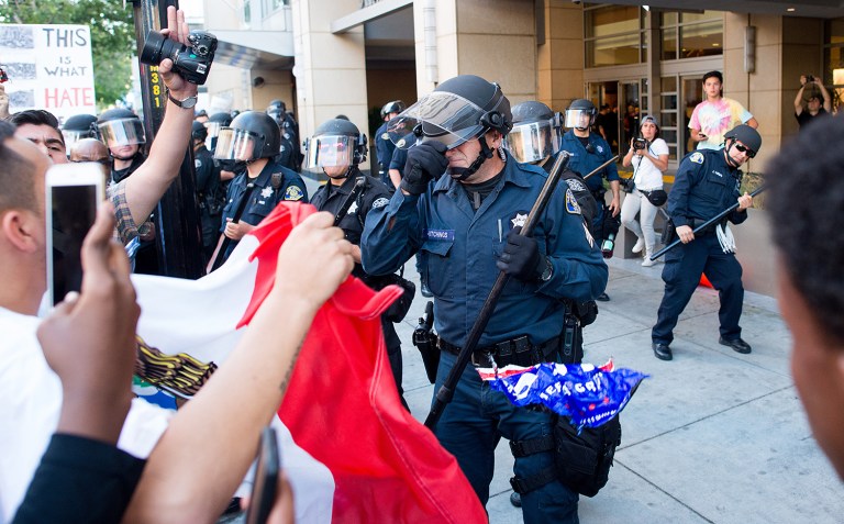 A group of protesters attacked Trump supporters who were leaving the candidate's rally in San Jose on June 2. A dozen or more people were punched, at least one person was pelted with an egg and Trump hats grabbed from supporters were set on fire on the ground. (AP Photo/Noah Berger)