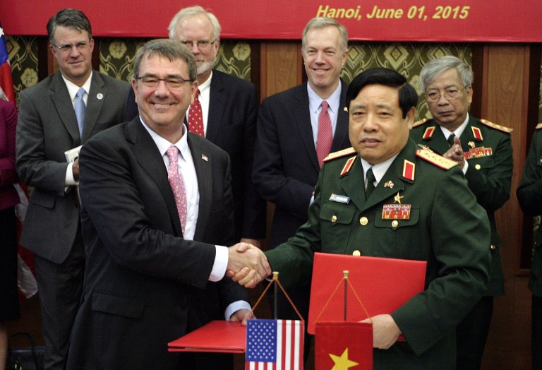 U.S. Defense Secretary Ashton Carter, front left, shakes hands with his Vietnamese counterpart Gen. Phung Quang Thanh, front right, after the two signed a joint vision statement between the two defense ministries in Hanoi, Vietnam Monday, June 1, 2015. Carter is on a three-day visit to Vietnam to deepen military cooperation between the two former foes. (AP Photo/Tran Van Minh.)