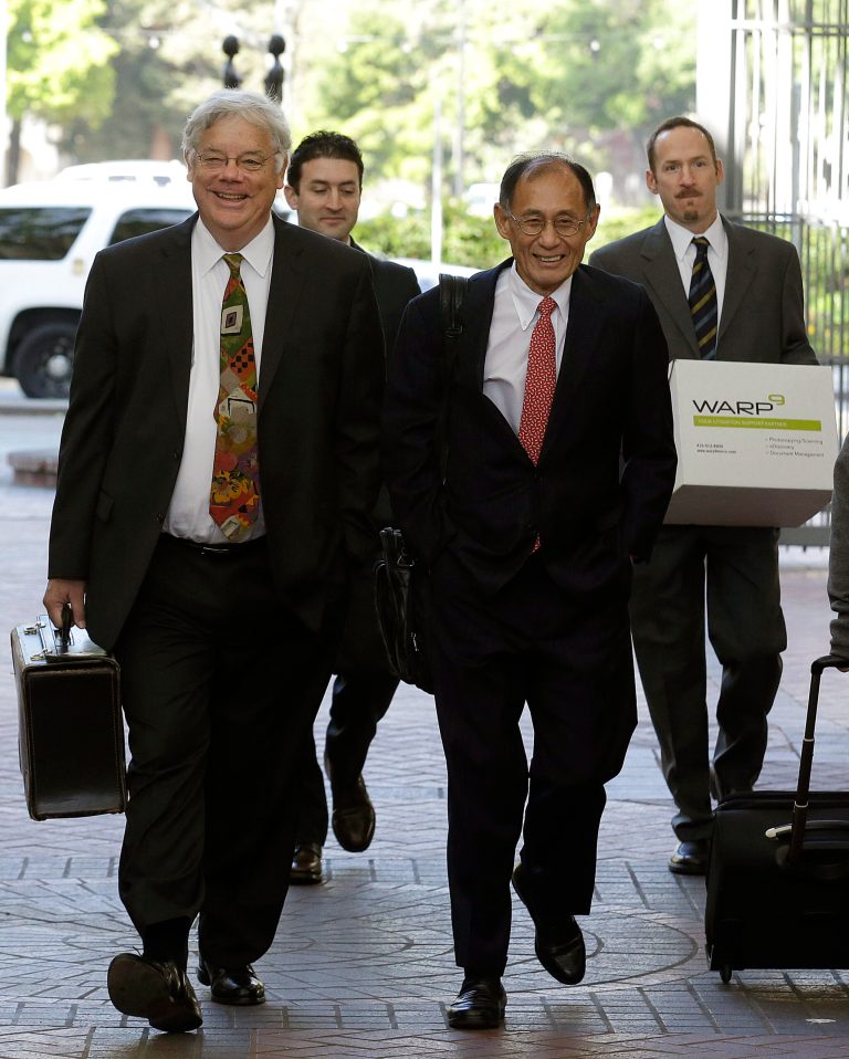 FILE - In this Monday, April 28, 2014, file photo,  Apple attorneys Harold McElhinny, left, and William Lee, walk with others to a federal courthouse in San Jose, Calif. A California jury determined Friday, May 2, 2014,  that Samsung infringed Apple smartphone patents and awarded $120 million damages.  (AP Photo/Jeff Chiu, File)