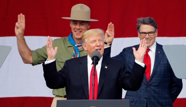 President Trump along with Interior Secretary Ryan Zinke, left, Energy Secretary Rick Perry, at the 2017 National Boy Scout Jamboree. The Interior and Energy departments are pushing forward with a number of new rules while continuing 2017's theme of pulling back on regulations to reduce costs and spur economic growth. (AP Photo/Steve Helber)