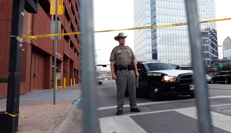 A Texas state trooper stands at a roadblock, Monday, July 11, 2016, in Dallas, near the area where five police officers were killed by a sniper in July. (AP Photo/Eric Gay)