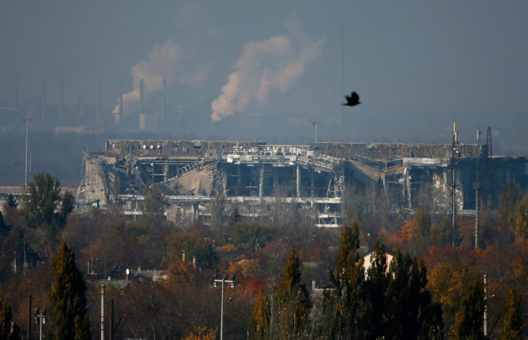The normally functioning Avdeyevsky chemical plant is seen behind the main terminal of Donetsk Sergey Prokofiev International Airport hit by shelling during artillery battles between pro-Russian rebels and Ukrainian government forces in the town of Donetsk, eastern Ukraine Friday, Oct. 17, 2014. Ukraine's president on Friday hailed progress in Europe-brokered talks aimed at ensuring peace with Russia, with agreements nearing on a gas dispute and local elections in the east. (AP Photo/Dmitry Lovetsky)