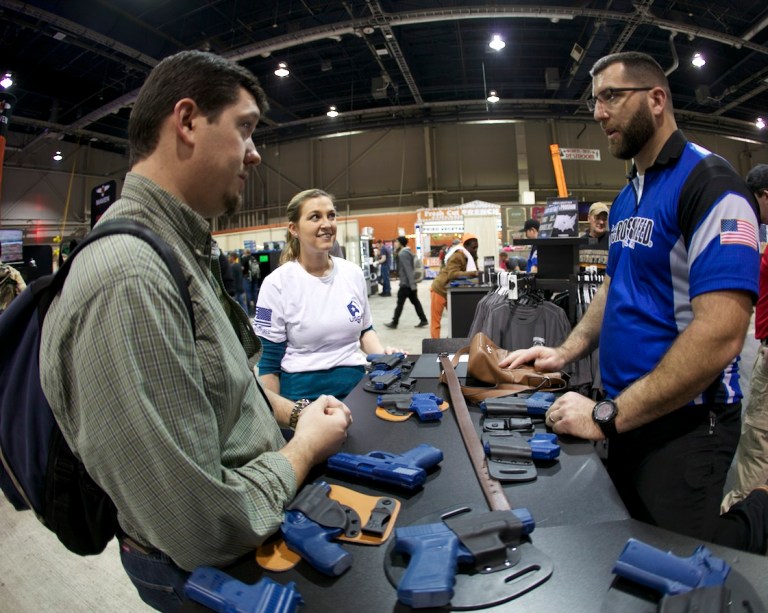 Republican candidate for Congress Rick Saccone (pictured right) and his wife, Yong, join a rally to support Martin Palla and gun rights on April 22 in the courtyard of the Westmoreland County Courthouse in Greensburg, Pa.