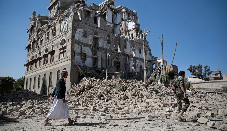 Houthi Shiite rebels walk amid the rubble of the Republican Palace that was destroyed by Saudi-led airstrikes, in Yemen. (AP Photo/Hani Mohammed)