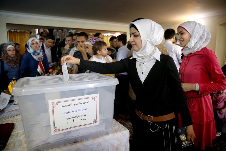 A Syrian woman who lives in Iran casts her ballot for her country's presidential election at the Syrian Embassy in Tehran, Iran, Wednesday, May 28, 2014, as expat voting started ahead of Syria's June 3 presidential election - a vote highly contentious amid the civil war but one that is widely expected to give the Syrian president a third seven-year term in office. (AP Photo/Ebrahim Noroozi)