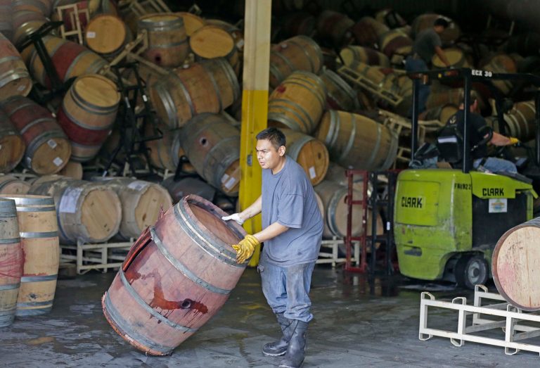 A worker removes an earthquake-damaged wine barrel from a barrel storage facility Monday, Aug. 25, 2014, in Napa, Calif. A powerful earthquake that struck the heart of California's wine country caught many people sound asleep, sending dressers, mirrors and pictures crashing down around them and toppling wine bottles in vineyards around the region. The magnitude-6.0 quake struck at 3:20 a.m. PDT Sunday near the city of Napa. (AP Photo/Eric Risberg)