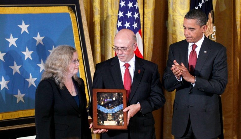 President Obama presents the Medal of Honor posthumously to the parents of U.S. Army Staff Sgt. Robert J. Miller, Phil, center, and Maureen Miller, left, Wednesday, Oct. 6, 2010. (AP Photo/Pablo Martinez Monsivais)