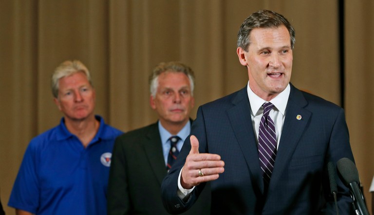 Charlottesville Mayor Mike Signer, right, said Monday that President Trump missed his chance to take a strong stand against white supremacism, by failing to identify it in a Saturday statement. (AP Photo/Steve Helber)