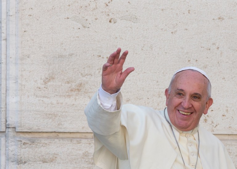 Pope Francis waves to members of the media as he leaves a morning session of a two-week synod on family issues, at the Vatican, Friday. (AP/Alessandra Tarantino)