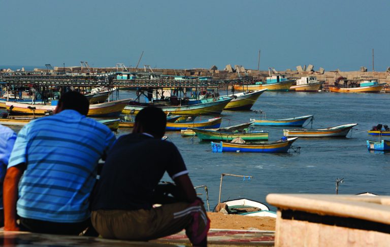 Palestinians sit by the port in Gaza City, Wednesday, Oct. 17, 2012. The Israeli military calculated the number of calories Gaza's residents would need to consume to avoid malnutrition during a sweeping blockade imposed on the Palestinian territory between 2007 and mid-2010, according to a document the Defense Ministry released reluctantly under a court order. (AP Photo/Adel Hana)