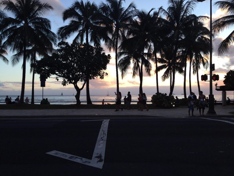 This Friday, Aug. 22, 2014, photo shows people walking along Waikiki Beach in Honolulu. State tourism officials planned to discuss industry goals for the upcoming year during a meeting Thursday, Aug. 28, 2014. (AP Photo/Mark Thiessen)