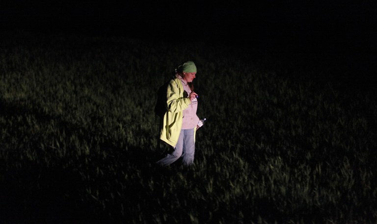 Stephanie Wheeling of Dayton, Ia., scans a ditch well into the night on Tuesday, May 21, 2013. Wheeling said she couldn't sit and do nothing while a girl was missing from her town. Kathlynn Shepard, 15, has been missing since Monday afternoon. (AP Photo/The Des Moines Register, Bryon Houlgrave) NO SALES