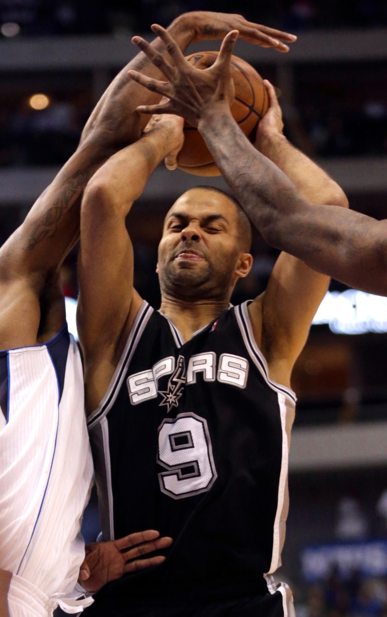   San Antonio Spurs guard Tony Parker (9), of France, gets tied up with the ball during the second half of an NBA basketball game against the Dallas Mavericks in Dallas on Sunday Dec. 30, 2012. San Antonio won 111-86. (AP Photo/Mike Fuentes)  