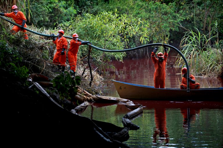 Workers from a company outsourced by Mexico's state-owned oil company Pemex try to remove fuel from the water after a pipeline spill of premium gasoline contaminated the Hondo River near the town of Tierra Blanca, Mexico, Sunday, Aug. 31, 2014. According to PEMEX, the Aug. 27 spill was caused by an illegal tap in the pipeline by criminals trying to steal fuel. (AP Photo/Felix Marquez)