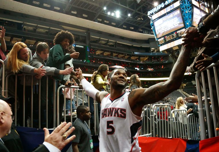   Atlanta Hawks small forward Josh Smith (5) celebrates with fans as he leaves the court after an NBA basketball game against the Detroit Pistons, Wednesday, Dec. 26, 2012, in Atlanta,. Atlanta won 126-119 in double overtime. (AP Photo/John Bazemore)  