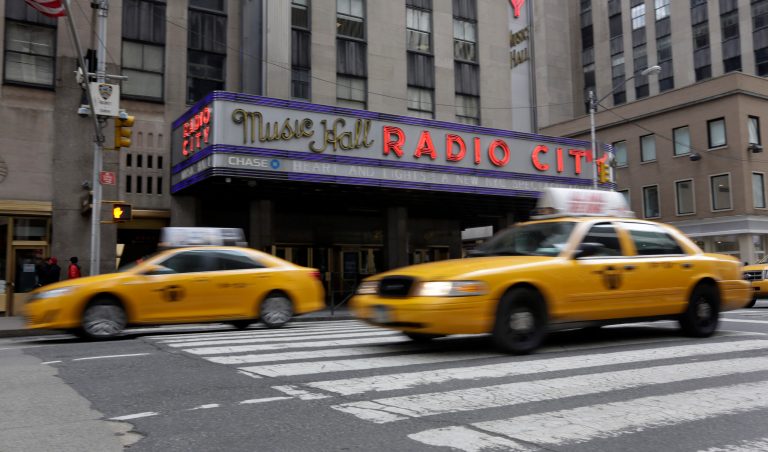 New York City taxis pass New York's Radio City Music Hall. (AP/Richard Drew)