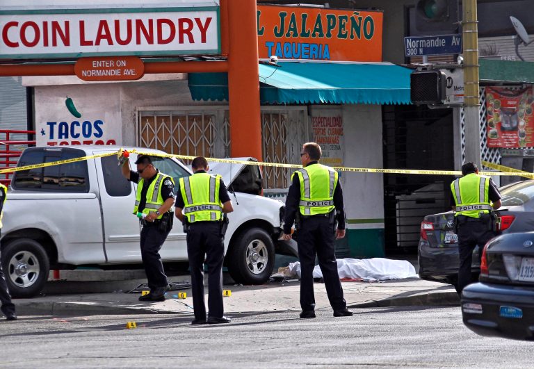 Los Angeles traffic officers investigates the scene at a fatal accident in Los Angeles Monday, July 28, 2014. The Los Angeles Fire Department says one pedestrian has been killed and two others injured by a vehicle west of downtown. (AP Photo/Nick Ut)