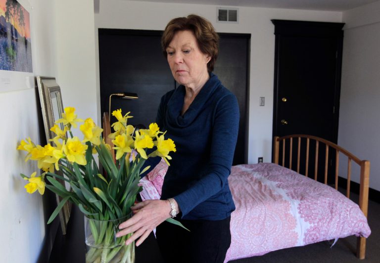 File - In this Jan. 25, 2014 file photo, Lorraine Rorke Bader arranges fresh flowers in a room at her home before an overnight guest arrives in San Francisco. Bader rents out the room, with a 3-night minimum stay, for $120 a day using the Airbnb service. Legislation set to be unveiled Tuesday, April 15, 2014, by a San Francisco supervisor would make it legal for city residents to rent out their homes on sites such as Airbnb, but only if they have liability insurance and meet other requirements. (AP Photo/San Francisco Chronicle, Paul Chinn, File)