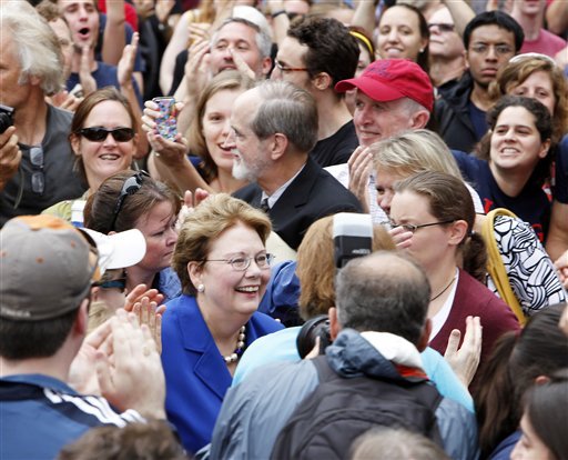 University of Virginia President Teresa Sullivan smiles as she makes her way through the crowd to meet with the U.Va. Board of Visitors. (AP photo)