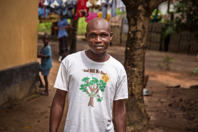 In this photo taken Monday, Aug. 11, 2014, Sulaiman Kemokai a Ebola virus survivor near his house in the Heigbema Village in Kenema  situated in the Eastern Province around 300km, (186 miles),  from the capital city of Freetown in Kenema, Sierra Leone.  In Sierra Leone, Sulaiman Kemokai, 20, was released from an Ebola treatment center on Sunday after spending 25 days in a ward there. He still feels stiffness in his joints but says he is gaining strength each day. (AP Photo/ Michael Duff)