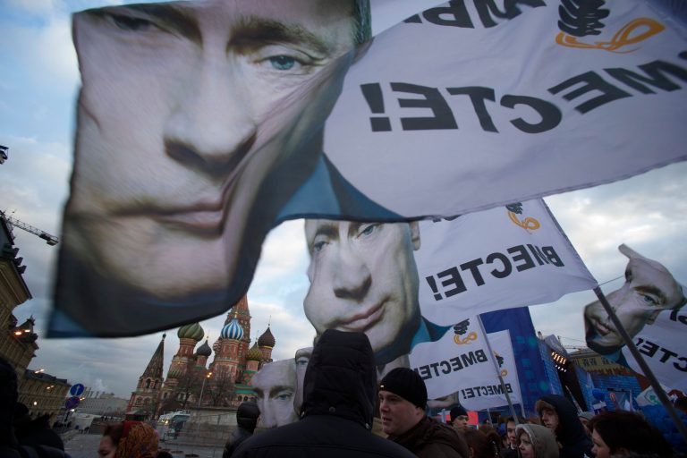 People rally in support of Crimea joining Russia, with banners and portraits of Russian President Vladimir Putin, reading, 