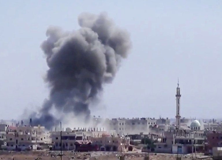 Smoke rises from buildings due to heavy shelling in Daraa, Syria on Tuesday. (AP Photo/Ugarit News via AP video)
