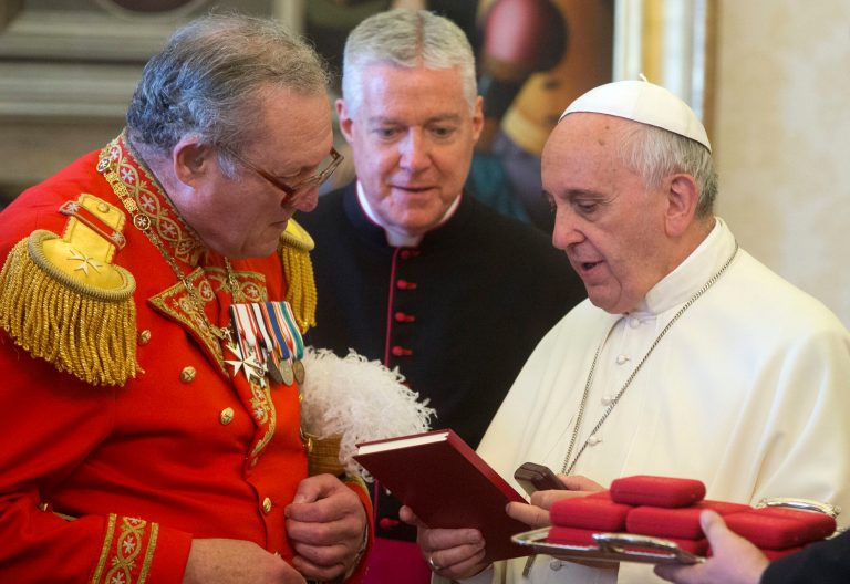Pope Francis exchange gifts with the Grand Master of the Sovereign Order of Malta, Fra' Matthew Festing, during a private audience in the pontiff's private library at the Vatican, Friday, June 20, 2014. (AP Photo/Claudio Peri, Pool)