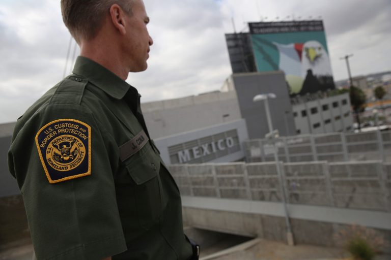 U.S. Border Patrol agent Jerry Conlin stands on the American side of the U.S.-Mexico border on October 3, 2013 at the San Ysidro port of entry into Mexico, California. (Photo by John Moore/Getty Images)