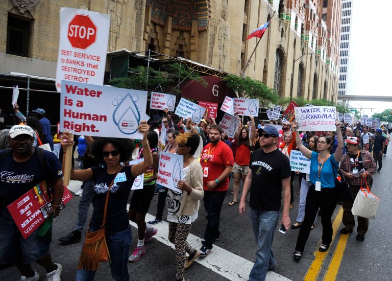 Protesters march over the controversial water shut-offs Friday, July 18, 2014, in Detroit, Mich.  (AP Photo/Detroit News, David Coates)