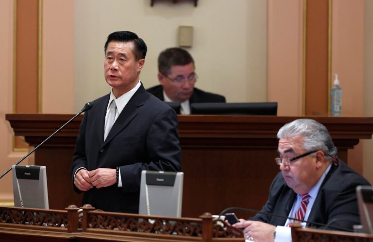 State Sen. Leland Yee, D-San Francisco, left, speaks on a bill, while his seat mate  Sen. Ron Calderon, D-Montebello, works at his desk at the Capitol  in Sacramento, Calif. In the wake the recent indictments of Yee and Calderon on federal corruption charges lawmakers are proposing to strengthen political ethics and reform campaign finance laws.(AP Photo/Rich Pedroncelli, file)