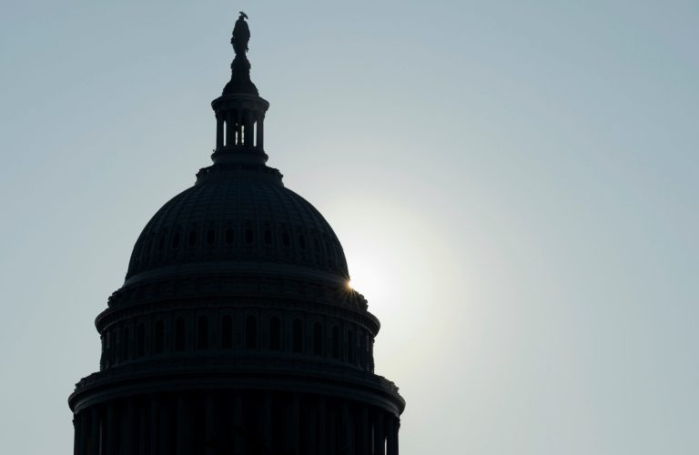 The sun peeks from behind the Capitol dome on Capitol Hill in Washington on Friday. (AP/Susan Walsh)