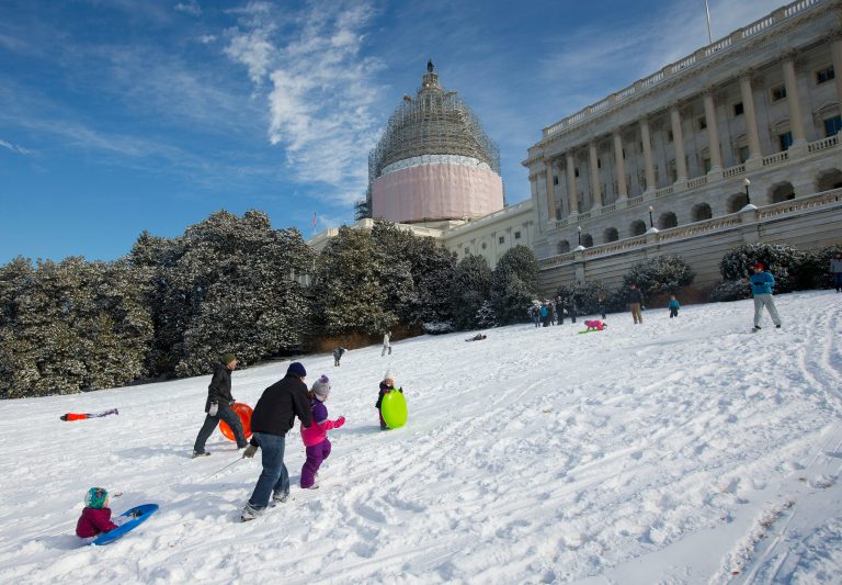 People sled together on the slope on the southwest grounds of the US Capitol after a winter storm, on Tuesday, Feb. 17, 2015 in Washington. US Capitol Police officers later told parents and kids that sledding was prohibited on the US Capitol grounds. Rules implemented after the Sept. 11, 2001 terrorist attacks made sledding on the Capitol grounds off limits to residents who try to take advantage of snowy weather. (AP Photo/Pablo Martinez Monsivais)