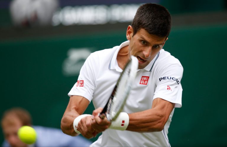 Novak Djokovic of Serbia plays a return to Andrey Golubev of Kazakhstan during their first round match at the All England Lawn Tennis Championships in Wimbledon, London,  Monday, June  23, 2014. (AP Photo/Pavel Golovkin)